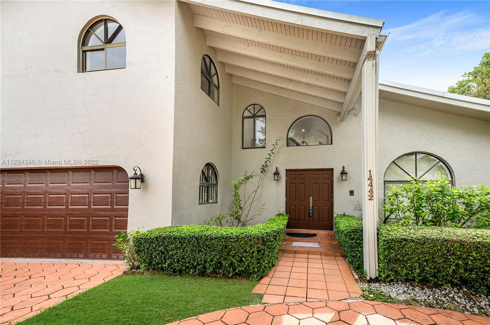 14442 Southwest 111th Street Miami, FL 33186 - Photo 5 of 15 a front view of a house with garden