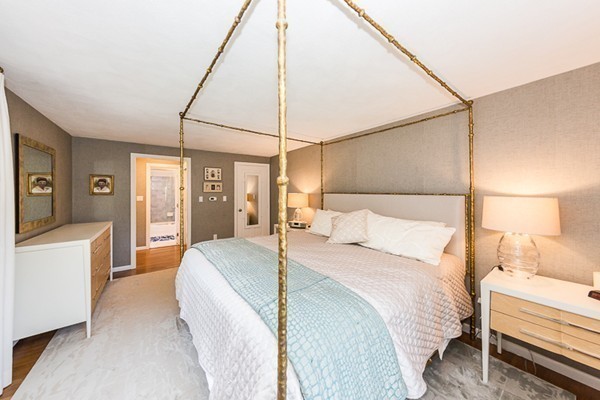 131 River Road Topsfield, MA 01983 - Photo 13 of 30 a bedroom with a bed and a chandelier