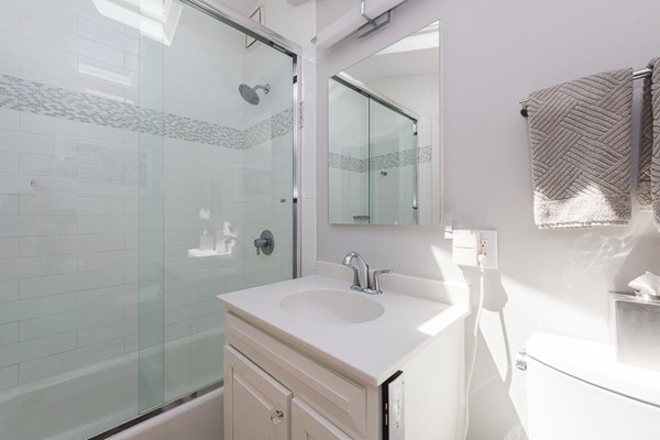 131 River Road Topsfield, MA 01983 - Photo 19 of 30 a bathroom with a sink a mirror and a shower