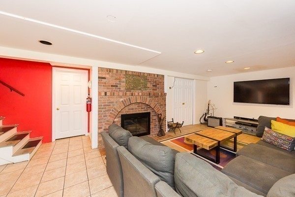 131 River Road Topsfield, MA 01983 - Photo 21 of 30 a living room with furniture flat screen tv and a fireplace