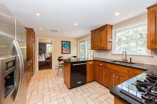 131 River Road Topsfield, MA 01983 - Photo 8 of 30 a large kitchen with stainless steel appliances granite countertop a stove a sink dishwasher and a refrigerator