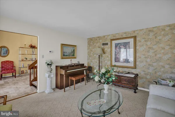 a living room with fireplace furniture and a rug