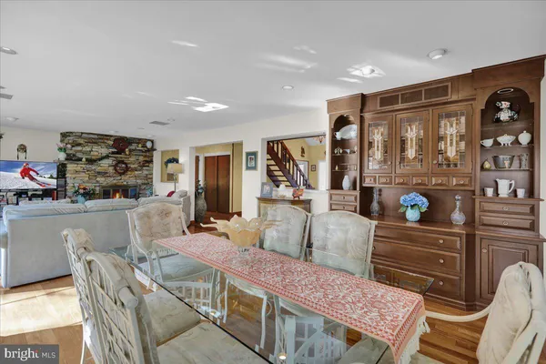 a kitchen with granite countertop a stove a oven a sink dishwasher and cabinets with wooden floor