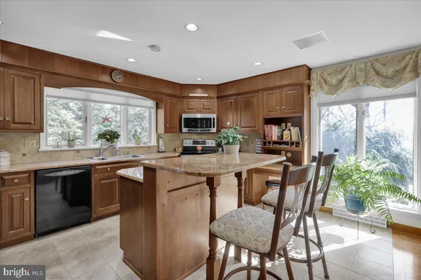 a kitchen with a sink a stove and cabinets