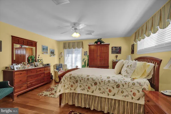 a bedroom with a bed couch and a dresser