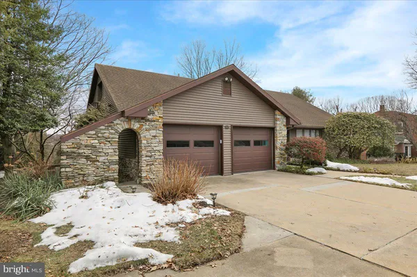 a front view of a house with a yard covered with snow in front of house