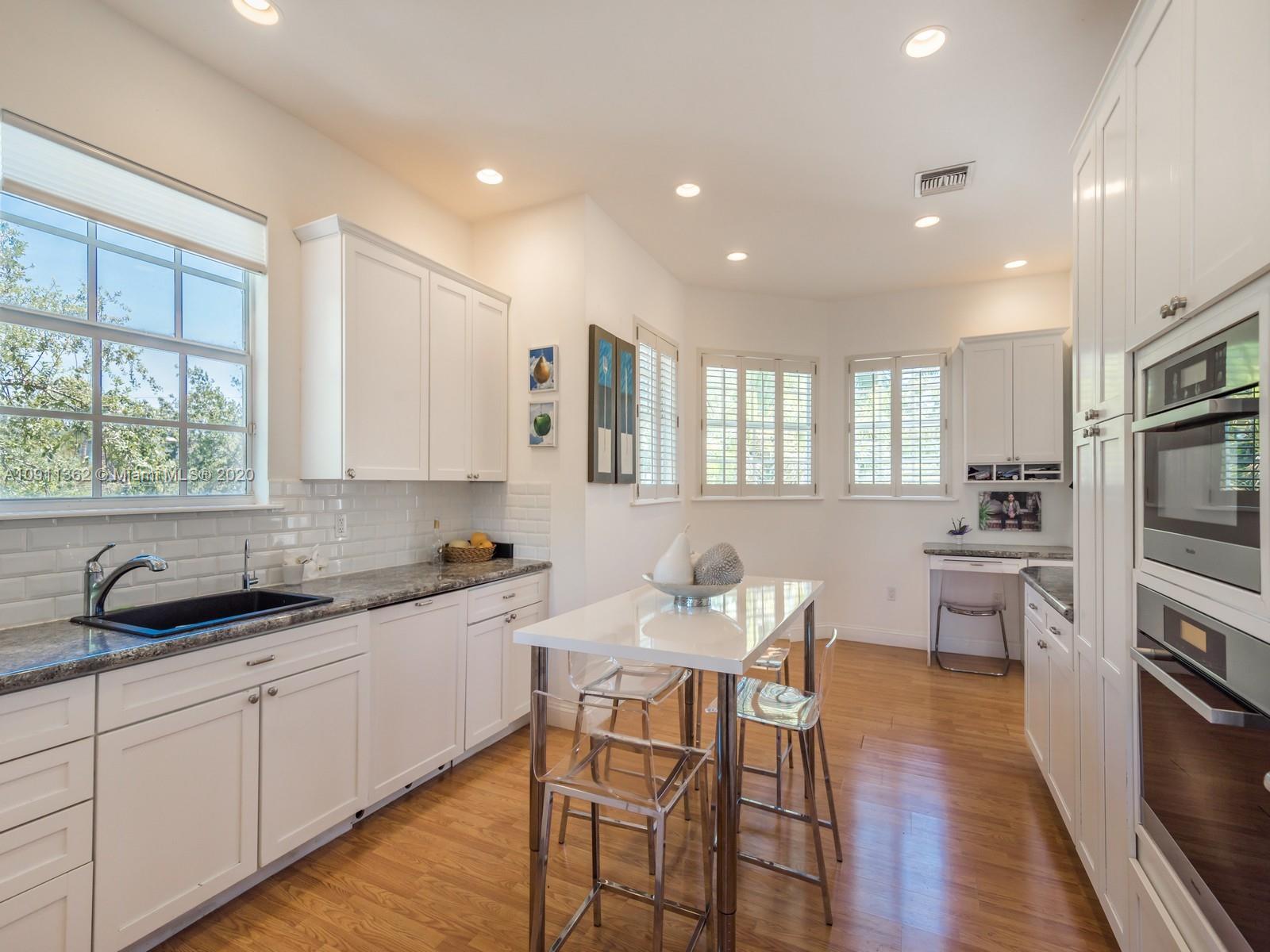 325 Pacific Road Key Biscayne, FL 33149 - Photo 12 of 31 a kitchen with a sink and cabinets