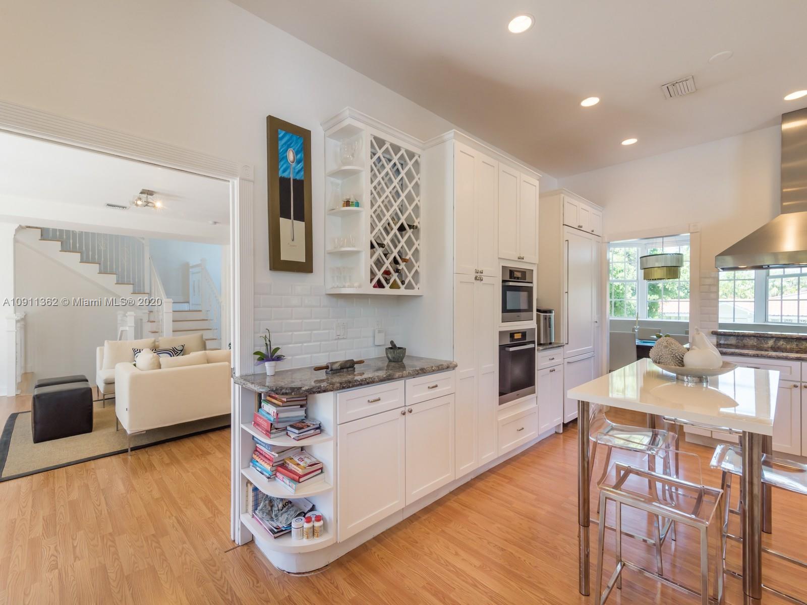 325 Pacific Road Key Biscayne, FL 33149 - Photo 13 of 31 a kitchen with a wooden floor and large windows