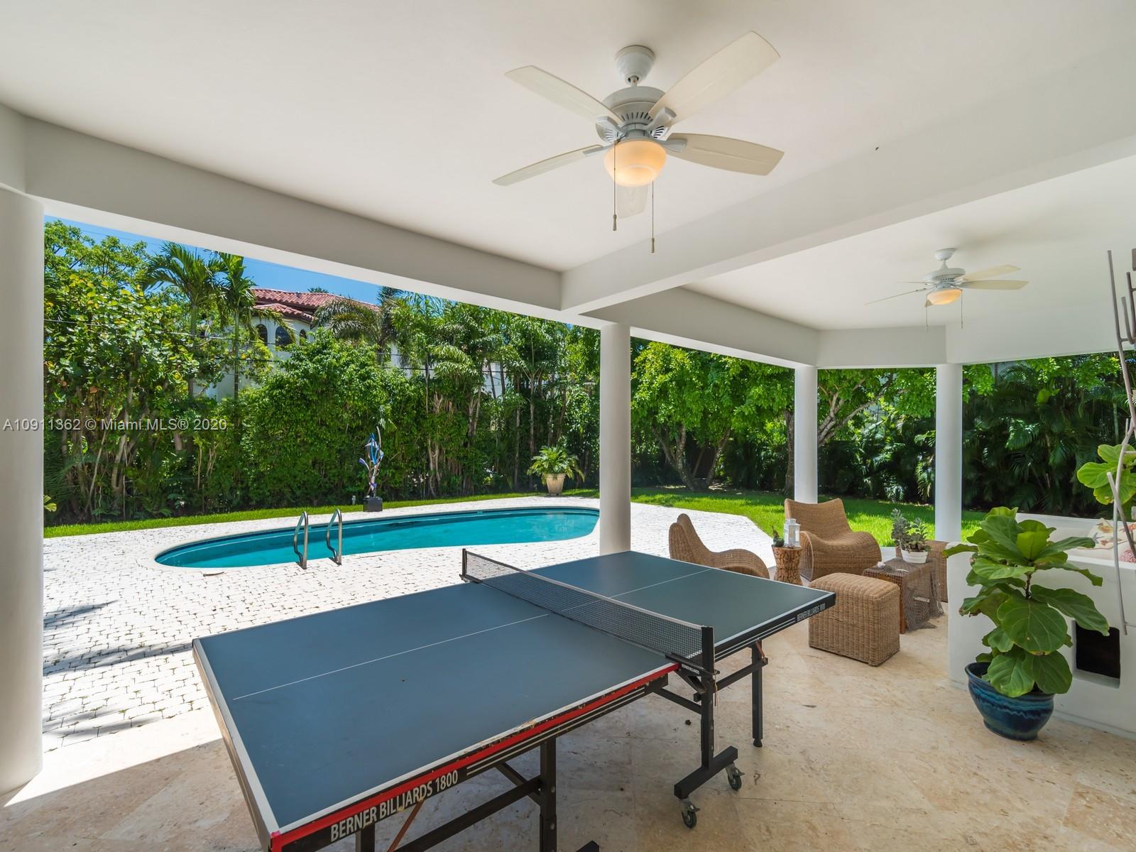 325 Pacific Road Key Biscayne, FL 33149 - Photo 24 of 31 a view of a patio with a table chairs and a table