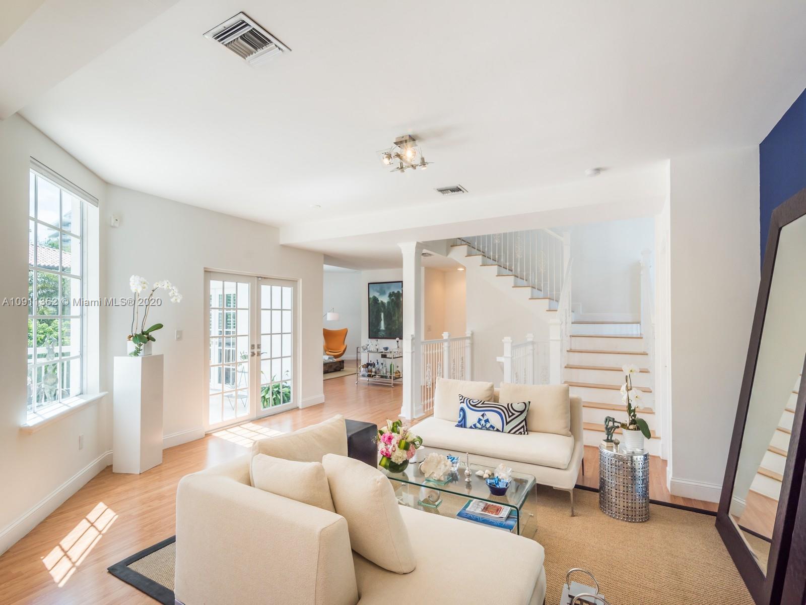 325 Pacific Road Key Biscayne, FL 33149 - Photo 3 of 31 a living room with furniture and a large window