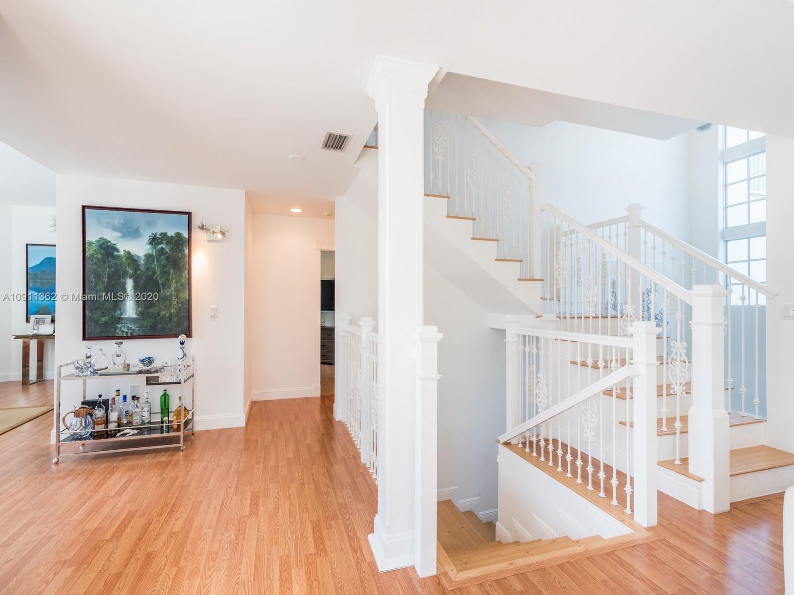 325 Pacific Road Key Biscayne, FL 33149 - Photo 5 of 31 a view of entryway and hall with wooden floor