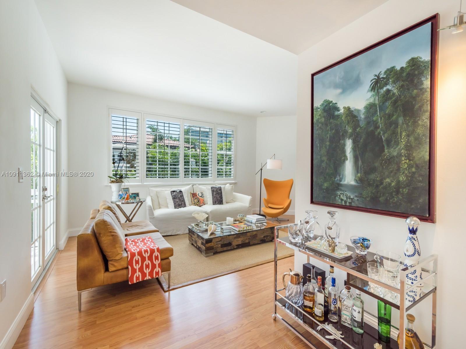 325 Pacific Road Key Biscayne, FL 33149 - Photo 7 of 31 a living room with furniture and a flat screen tv
