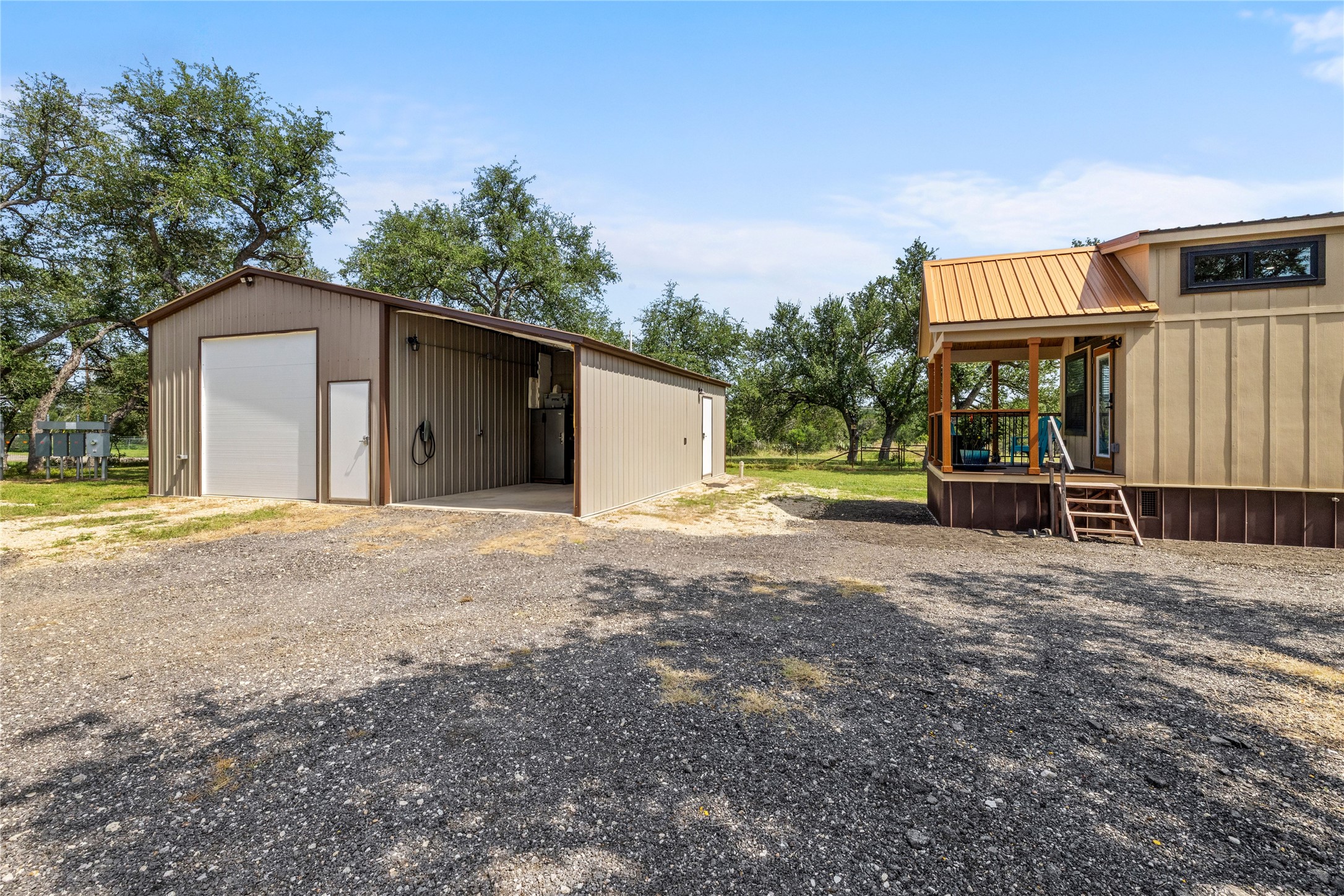 8200 Ranch Road 12 San Marcos, TX 78666 - Photo 32 of 40 A quaint porch entry complements the durable metal siding and practical detached garage.
