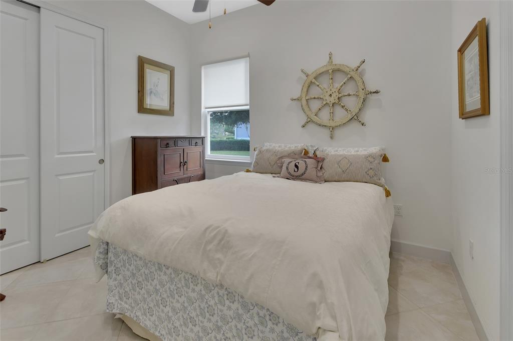 308 Locksley Court Deland, FL 32724 - Photo 21 of 56 a bedroom with a bed and a painting on the wall