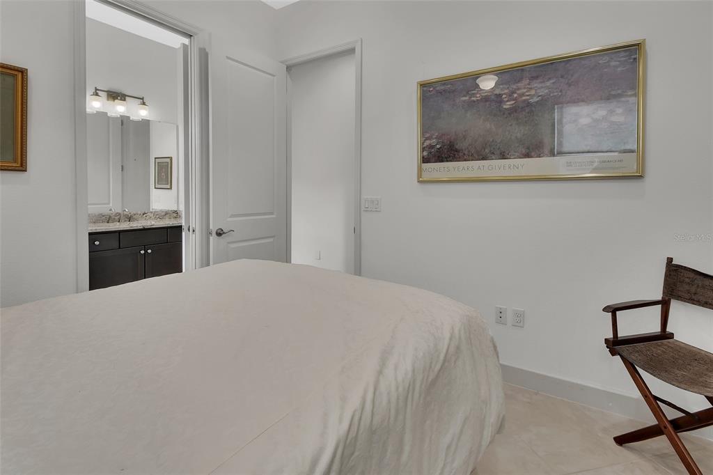308 Locksley Court Deland, FL 32724 - Photo 22 of 56 a bedroom with a bed and a painting on the wall