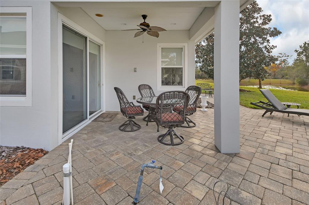 308 Locksley Court Deland, FL 32724 - Photo 30 of 56 a view of a patio with table and chairs and potted plants
