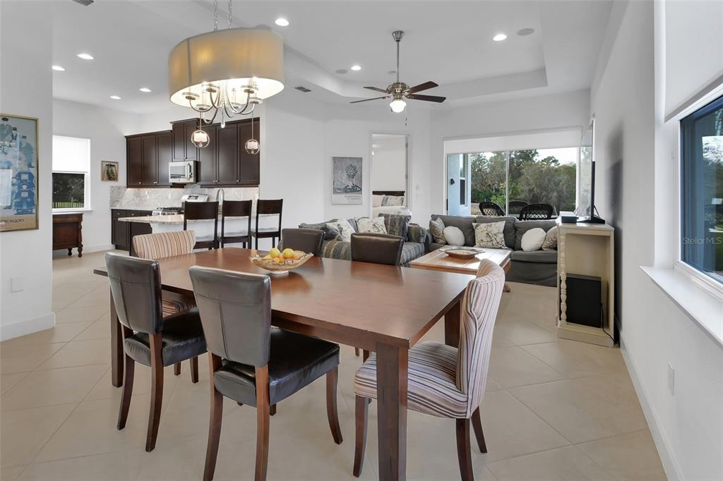 308 Locksley Court Deland, FL 32724 - Photo 3 of 56 a view of a dining room with furniture a livingroom and chandelier