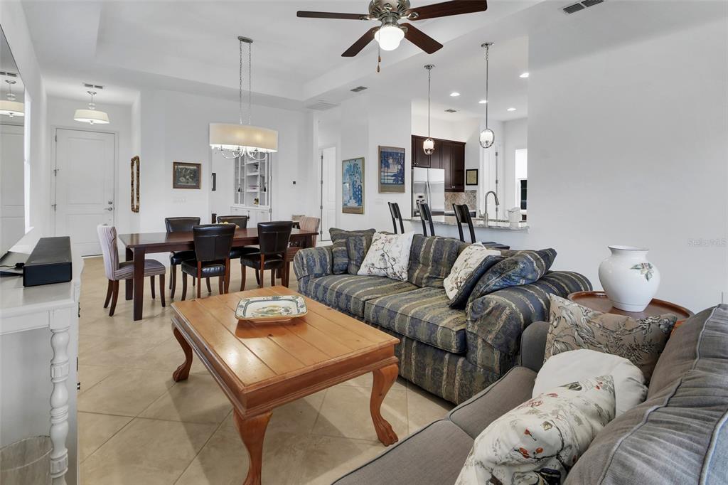 308 Locksley Court Deland, FL 32724 - Photo 5 of 56 a living room with furniture kitchen view and a chandelier