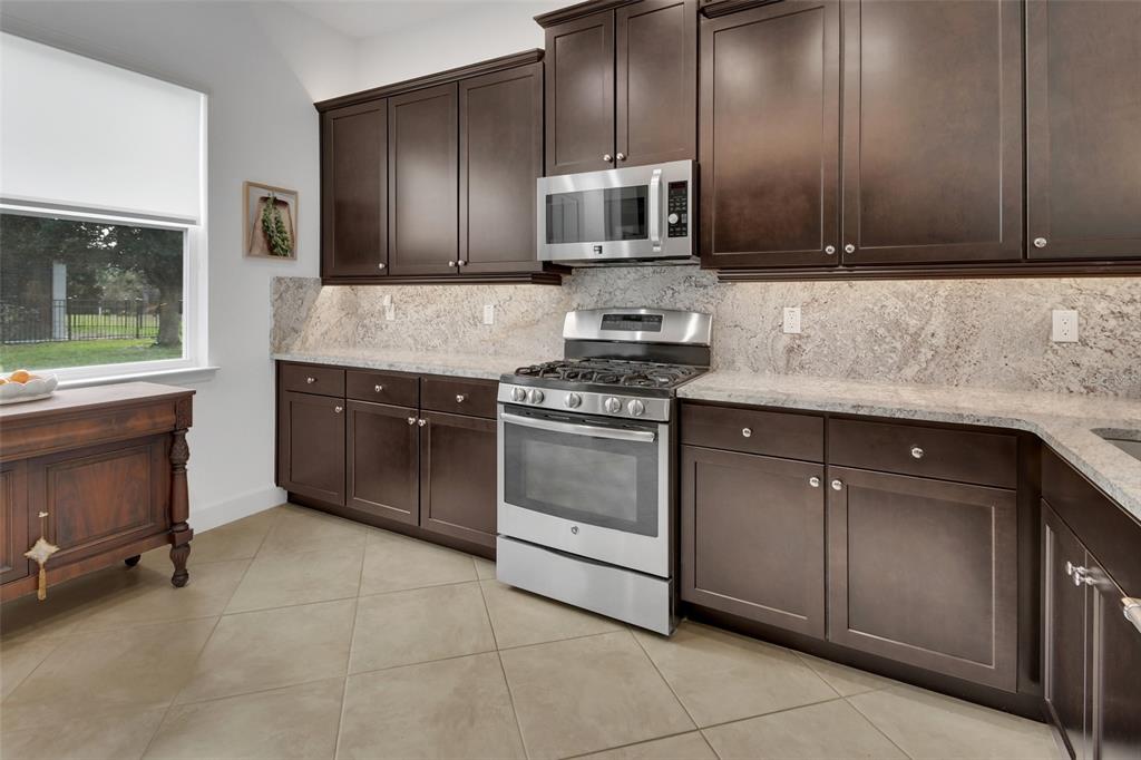 308 Locksley Court Deland, FL 32724 - Photo 7 of 56 a kitchen with cabinets a sink and appliances