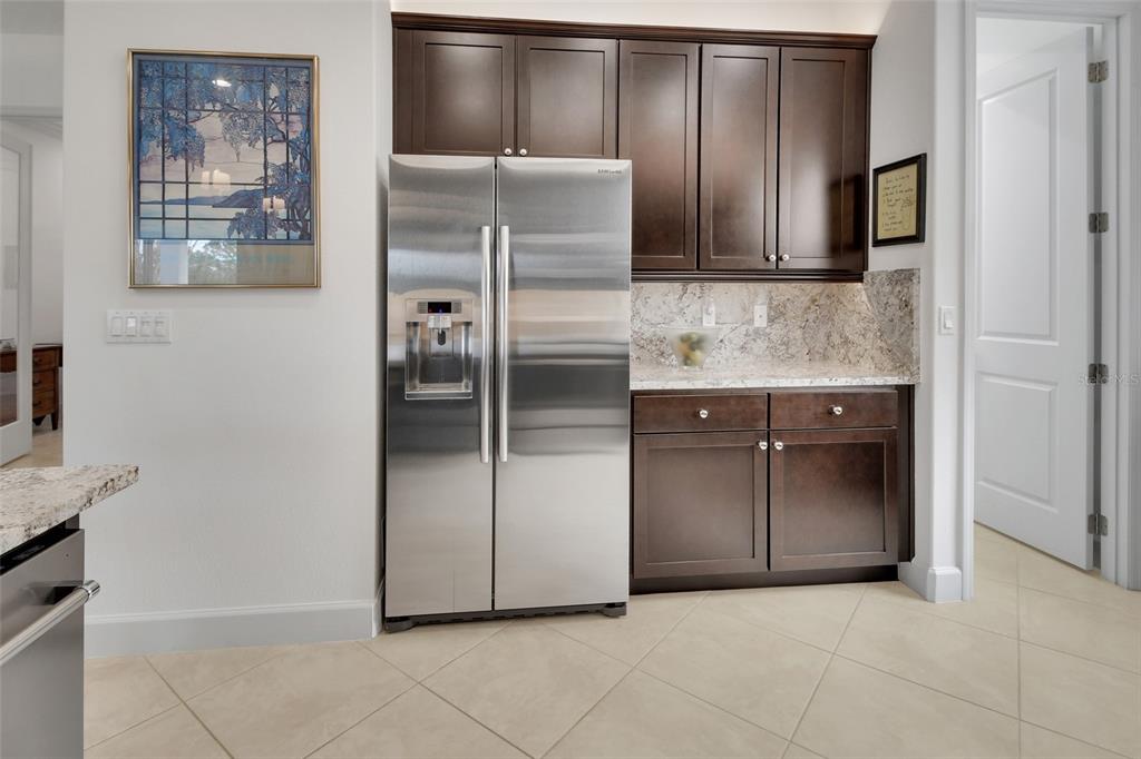 308 Locksley Court Deland, FL 32724 - Photo 8 of 56 a kitchen with stainless steel appliances granite countertop a refrigerator and a stove