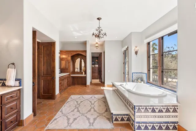 a spacious bathroom with a sink double vanity and a mirror