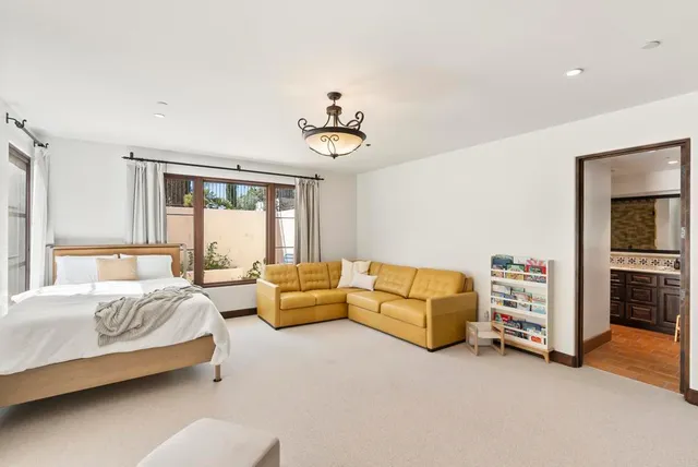 a bedroom with furniture and a chandelier