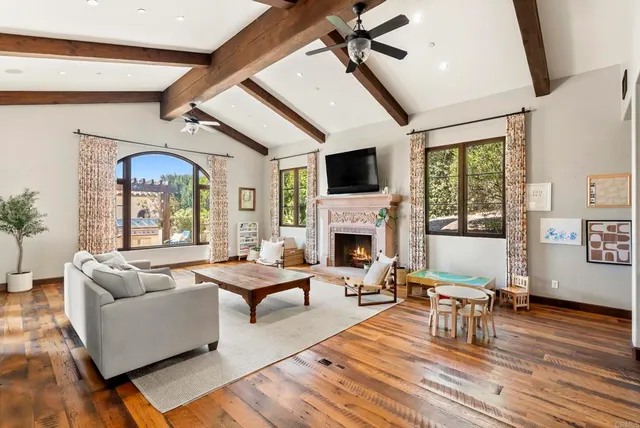 a living room with furniture fireplace and flat screen tv