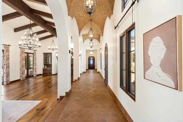 a view of a hallway with wooden floor and door