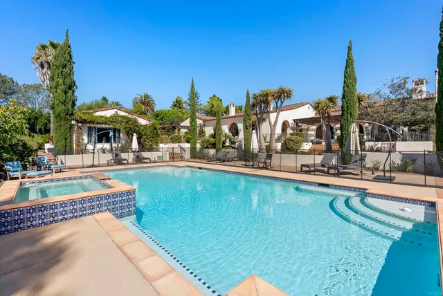 a view of a swimming pool and outdoor seating