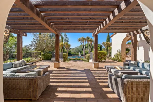 a outdoor living space with patio furniture and a rug