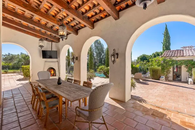 a view of a dining room with furniture a chandelier and wooden floor