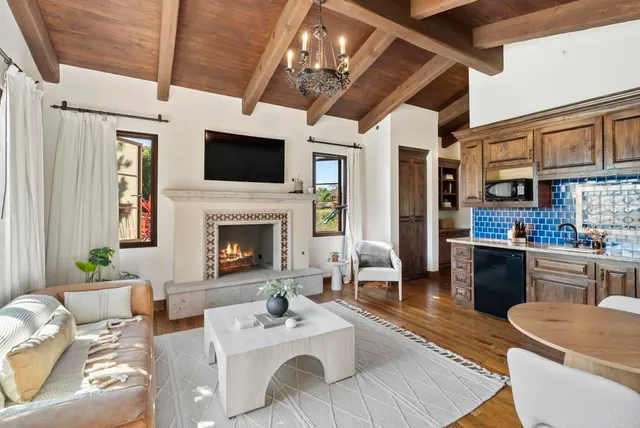 a living room with furniture a flat screen tv and a fireplace
