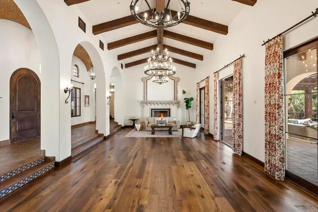 a view of a livingroom with wooden floor and a ceiling fan