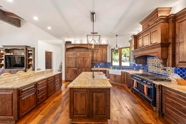 a kitchen with stainless steel appliances granite countertop a stove and a sink