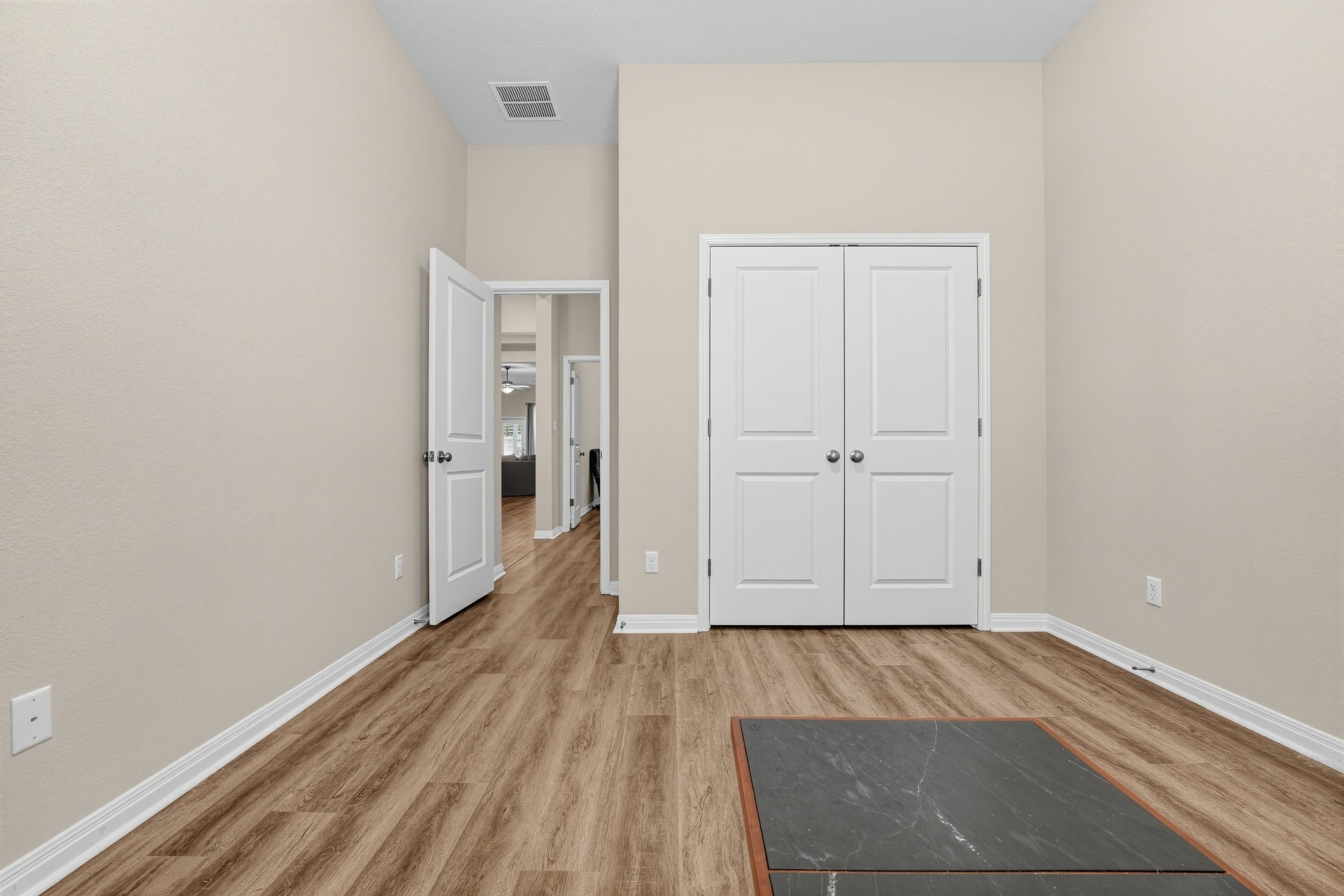145 Brooks Ranchi Drive Kyle, TX 78640 - Photo 24 of 40 Clean lines and rich wood-style flooring define this versatile interior space.