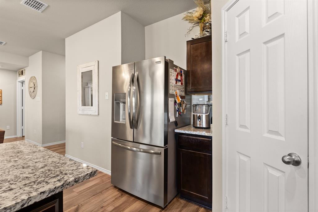 7209 Canadian Drive China Spring, TX 76633 - Photo 13 of 37 a kitchen with stainless steel appliances granite countertop a refrigerator and a sink