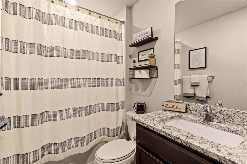 7209 Canadian Drive China Spring, TX 76633 - Photo 20 of 37 a bathroom with a granite countertop bathtub sink vanity mirror and toilet