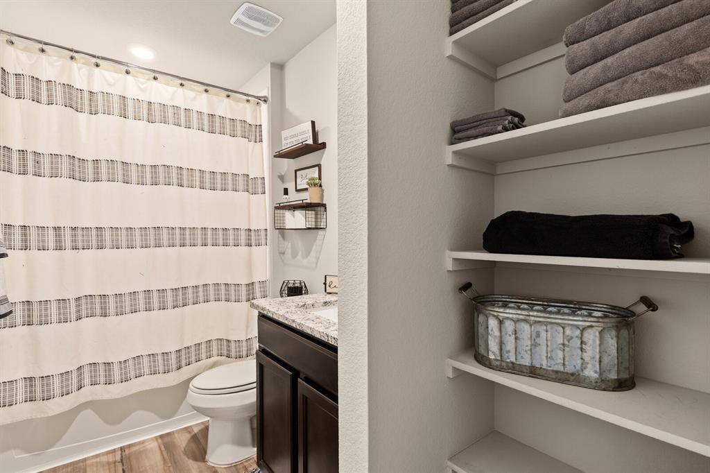 7209 Canadian Drive China Spring, TX 76633 - Photo 21 of 37 a bathroom with a toilet and a shower curtain