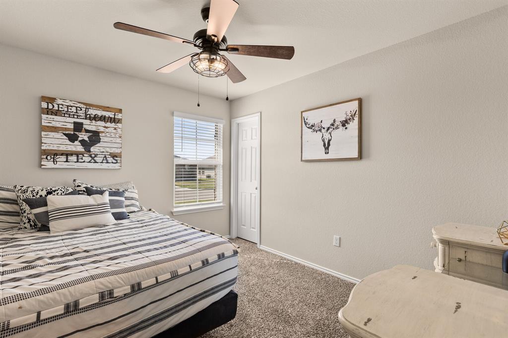 7209 Canadian Drive China Spring, TX 76633 - Photo 22 of 37 a bedroom with a bed and a chandelier