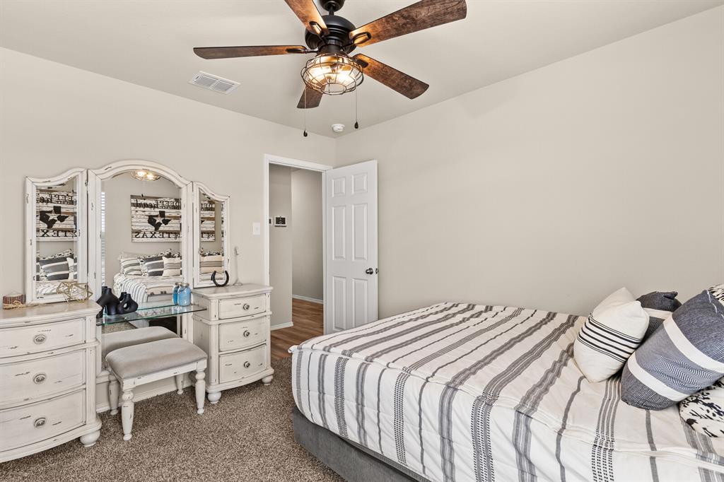 7209 Canadian Drive China Spring, TX 76633 - Photo 23 of 37 a bedroom with a bed and a chandelier