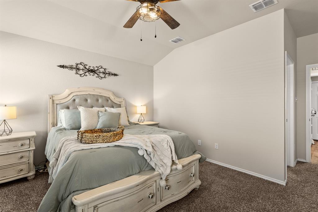 7209 Canadian Drive China Spring, TX 76633 - Photo 25 of 37 a bedroom with a bed and a chandelier