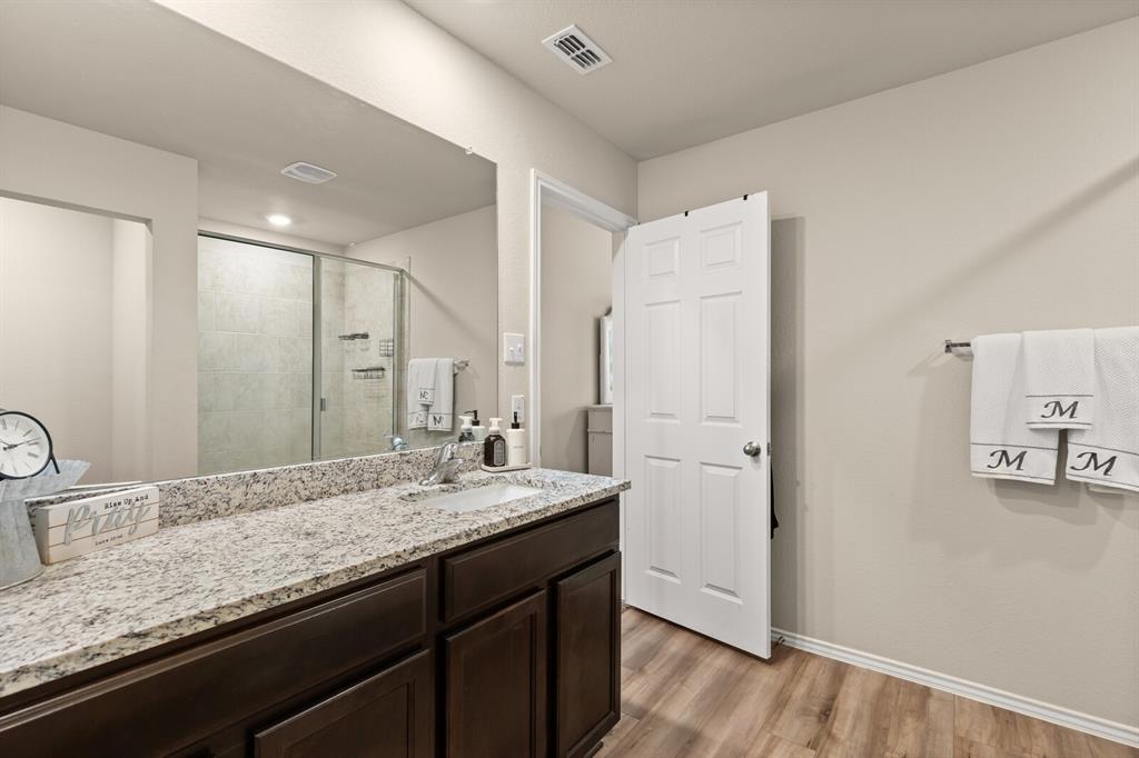 7209 Canadian Drive China Spring, TX 76633 - Photo 28 of 37 a bathroom with a granite countertop sink and a mirror
