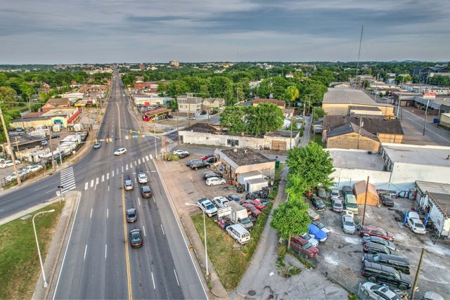 a view of a balcony with wooden floor and a potted plant