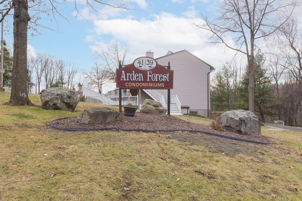 a view of a house with a yard and sitting area