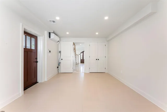 a kitchen with a table chairs and a refrigerator