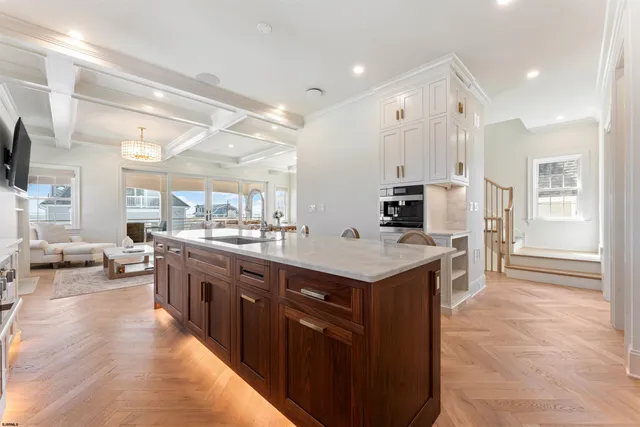 a kitchen with stainless steel appliances granite countertop a sink a stove and a refrigerator