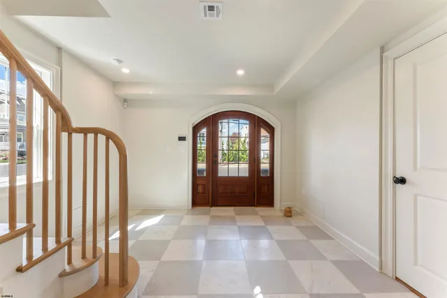 a view of a hallway with wooden floor and windows