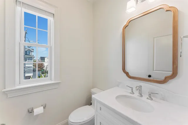 a view of a living room with furniture and a kitchen view