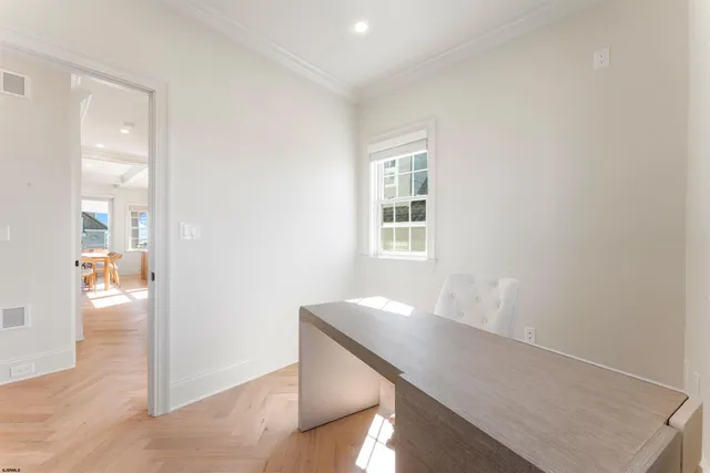 a spacious bedroom with a bed a mirror and a flat tv