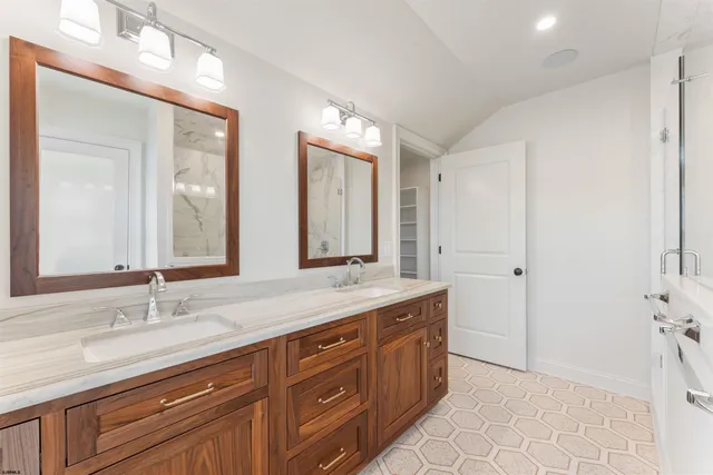 a view of a white house with a yard table and chairs